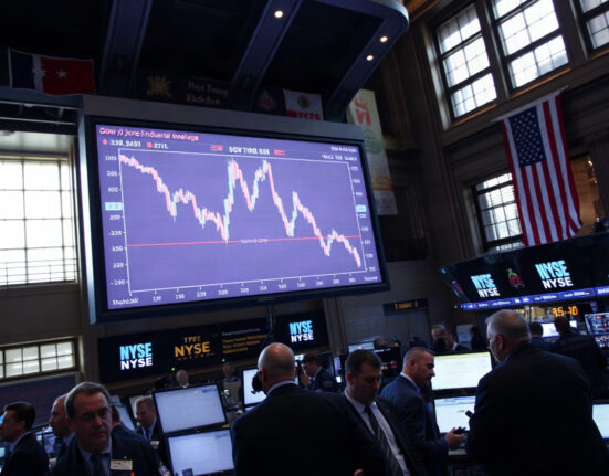 Traders on the NYSE floor watching a Dow chart decline, illustrating the term premium problem.