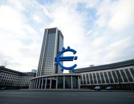 ECB headquarters in Frankfurt with Euro sculpture, representing inflation signals and monetary policy patience