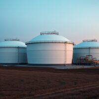 Natural gas storage facility at dusk with large spherical tanks and industrial infrastructure