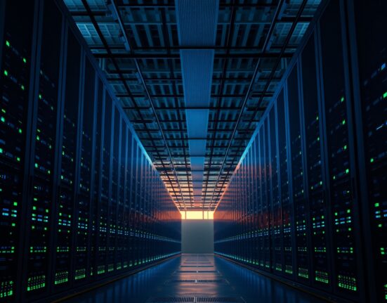 Interior of a large data center with rows of server racks, representing the energy demands of AI infrastructure.