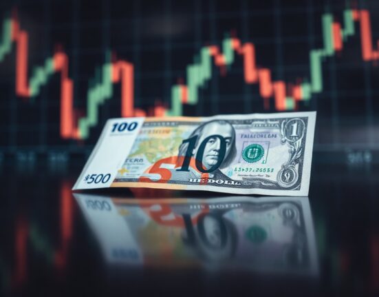 Euro and US Dollar banknotes on a reflective surface with a blurred chart in the background, representing currency exchange.