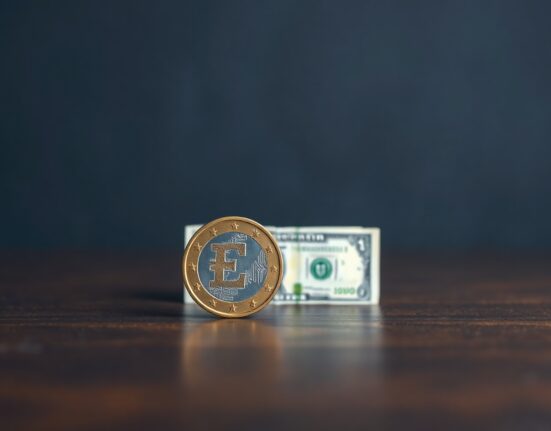 Euro coin and US dollar banknote on wooden surface representing EUR/USD exchange rate support level analysis