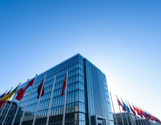 European Central Bank headquarters in Frankfurt on a sunny day with flags waving