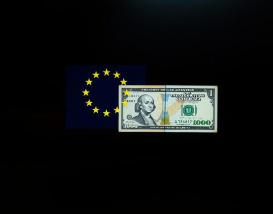 EU flag and US dollar banknote representing euro-dollar exchange rate under risk aversion