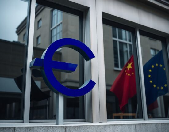 European Central Bank building in Frankfurt with EU and Chinese flag reflections, symbolizing euro sensitivity to trade and political factors