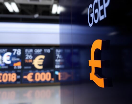 EUR/GBP exchange rate displayed on a digital trading screen in a financial news setting.