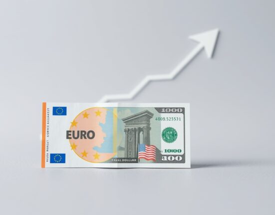 Euro banknotes and US dollars on a neutral background, symbolizing EUR/USD exchange rate analysis