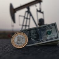Euro coin and US dollar bill on dark surface with oil pump jack silhouette in background