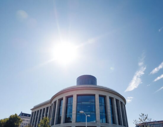 European Central Bank headquarters in Frankfurt on a sunny day, representing euro currency market analysis.
