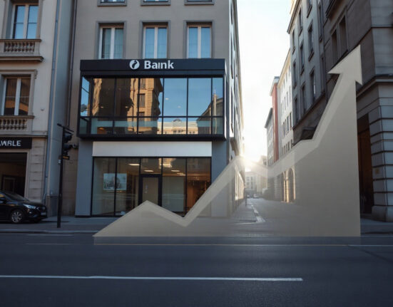 Modern bank building in a European city with a subtle rising graph overlay, symbolizing increased lending.