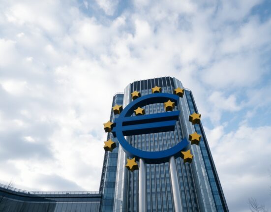 European Central Bank headquarters in Frankfurt with euro sculpture under cloudy sky