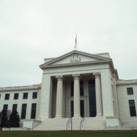 Federal Reserve building facade with a flat yield curve metaphor, illustrating BNY's late-2026 Fed cuts outlook.
