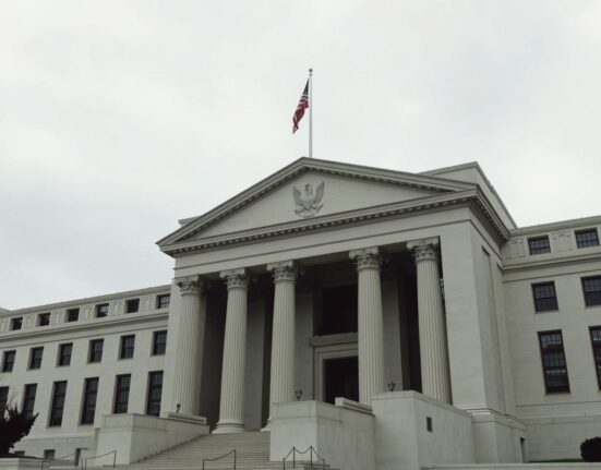 Federal Reserve building exterior with cloudy sky representing economic uncertainty from Middle East events in FOMC statement