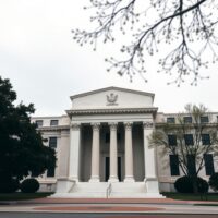 Exterior of the Federal Reserve building in Washington, D.C., under overcast skies.