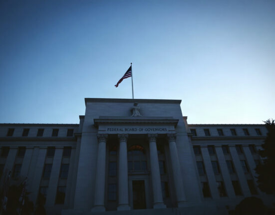 Federal Reserve building in Washington, D.C., with clear sky and evening light.