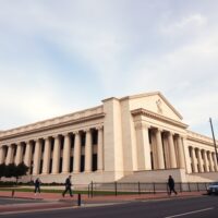 Exterior view of the Federal Reserve building in Washington, D.C., under overcast skies.