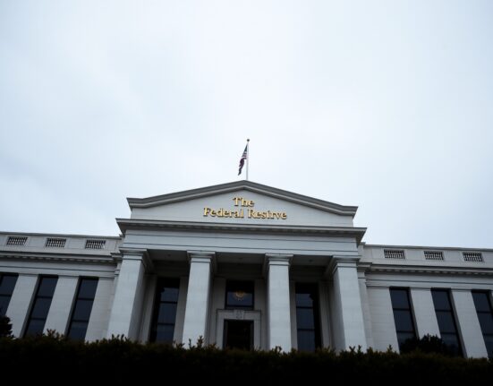 Exterior of the Federal Reserve building in Washington, D.C., on a cloudy day.