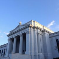 Exterior of the Federal Reserve building in Washington, D.C. on a sunny day.