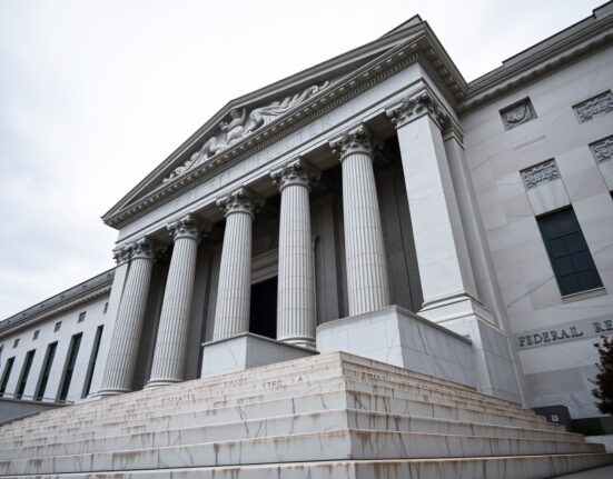 Exterior of the Federal Reserve building in Washington, D.C. under overcast sky
