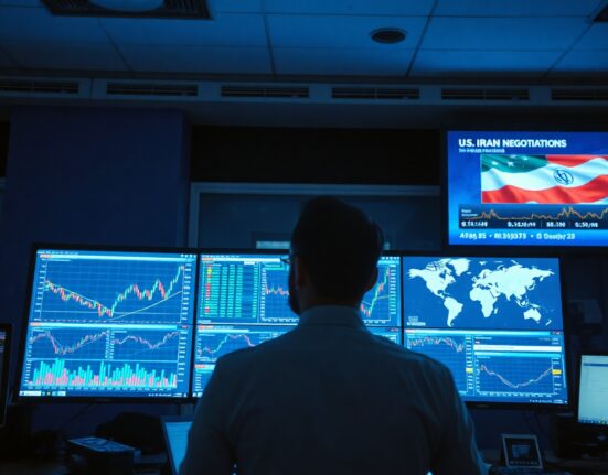 Trader monitors forex charts and geopolitical news in a financial newsroom