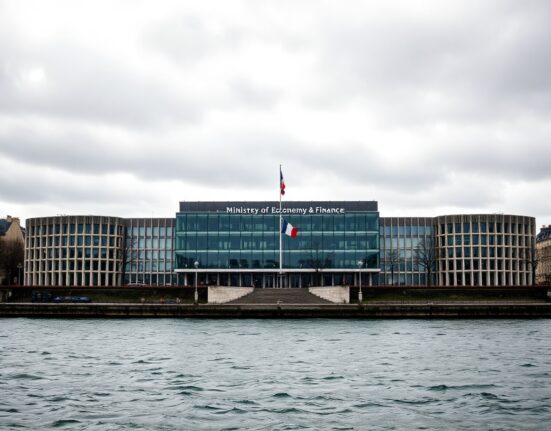 Exterior of the French Ministry of Economy and Finance building in Paris on a cloudy day.