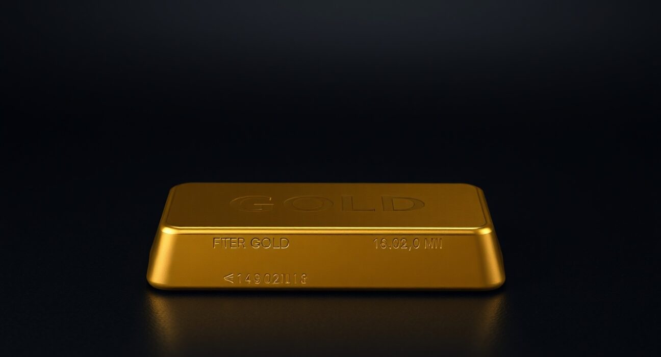 Close-up of a gold bullion bar on a dark surface, representing the flatlining gold price near $4,700.