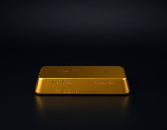 Close-up of a gold bullion bar on a dark surface, representing the flatlining gold price near $4,700.