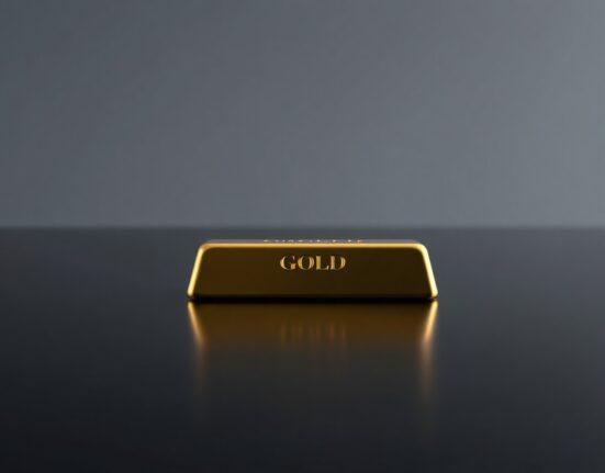 Gold bar on dark reflective surface representing precious metals market analysis and forecast revision.
