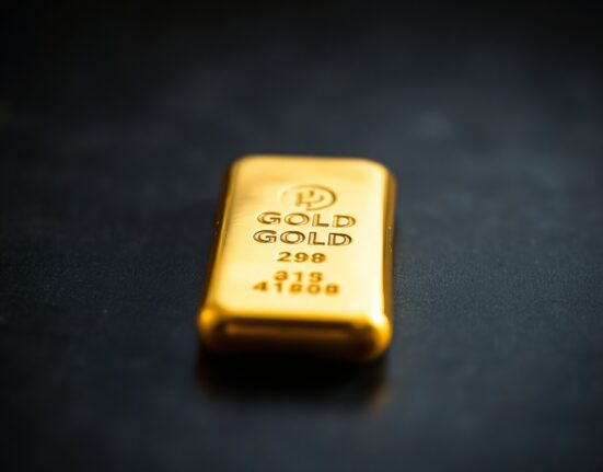 Close-up of a gold bar on a dark surface, representing precious metals market analysis.
