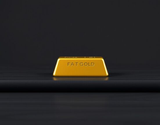 A gold bullion bar representing current market price movements amid Federal Reserve policy.