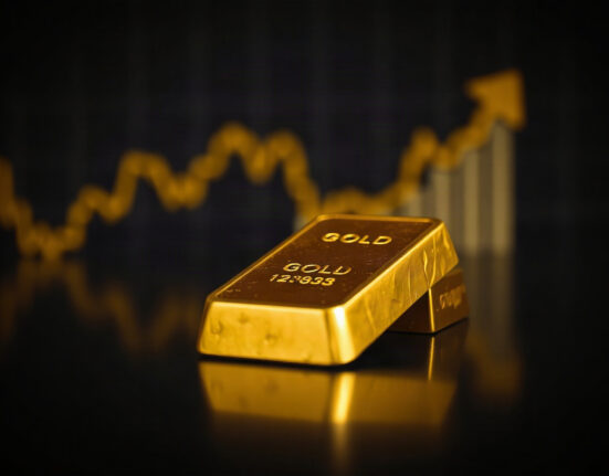 Gold bullion bar with a subtle price chart background, symbolizing bullish XAU/USD forecast