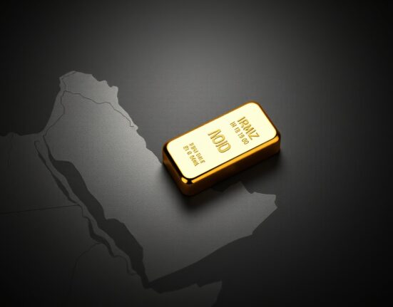 Gold bullion on a map of the Strait of Hormuz, symbolizing geopolitical risk impacting the gold price.