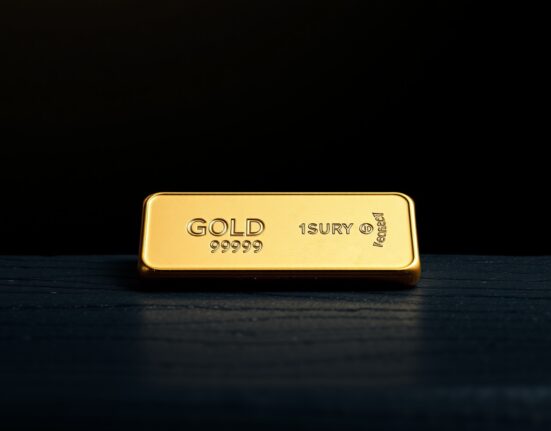 Gold bullion bar representing the surge in safe-haven asset prices amid geopolitical uncertainty.