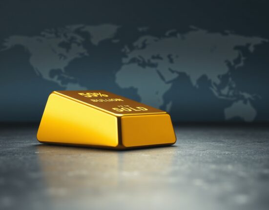 Gold bullion bar representing safe-haven asset during US-Iran geopolitical tensions.