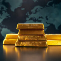 Gold bullion bars stacked on a dark surface, symbolizing haven demand amid geopolitical tensions.