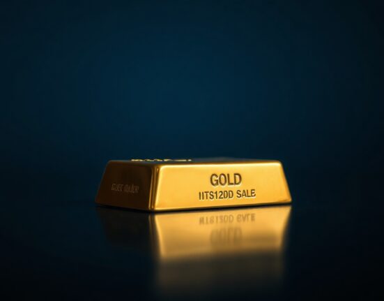 Gold bar on dark surface with subtle US dollar shadow reflecting market pressure