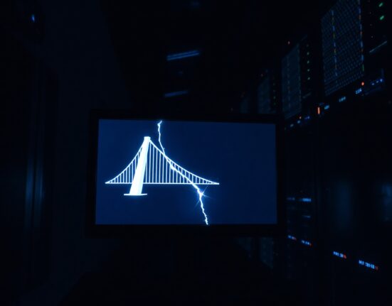 A cracked bridge graphic on a monitor in a dim server room, symbolizing the Gravity Bridge blockchain exploit.