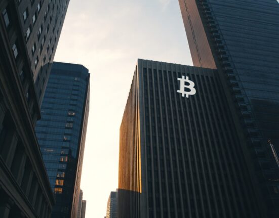 Modern financial building with a digital Bitcoin symbol in the sky, representing the Hashdex Bitcoin ETF closure