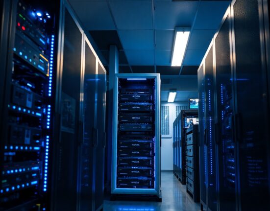 Interior of a modern data center with rows of GPU servers, illustrating HIVE Digital's AI cloud expansion.
