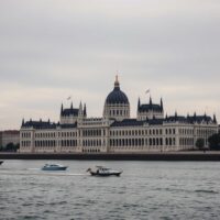 Hungarian Parliament building in Budapest under overcast sky, representing economic uncertainty.