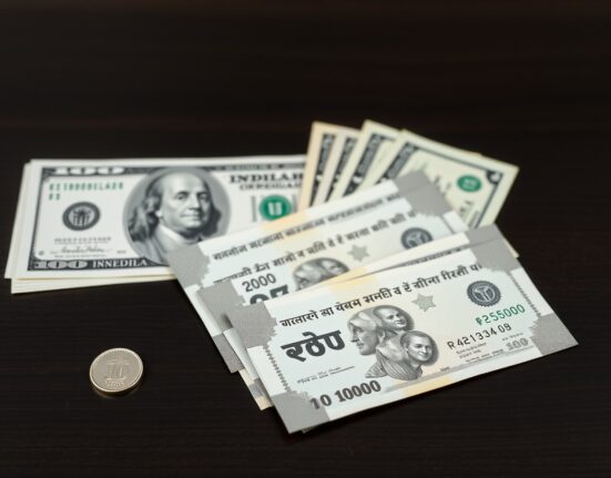 Indian Rupee and US Dollar banknotes arranged on a desk representing currency exchange rate analysis.