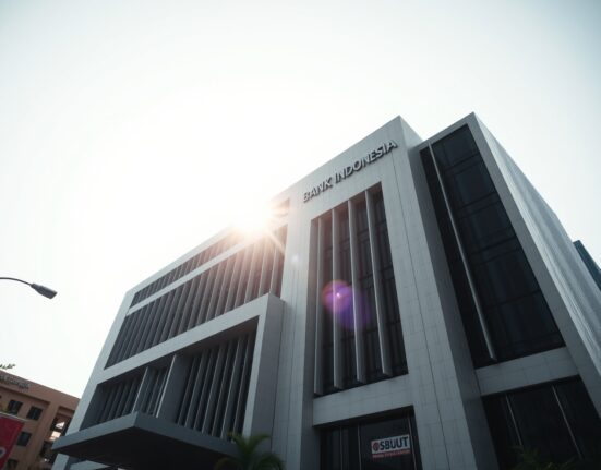 Bank Indonesia headquarters in Jakarta, a modern building under a clear sky, representing monetary policy focus.