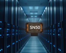 Data center aisle with SambaNova SN50 inference chip servers illuminated by blue LED lights