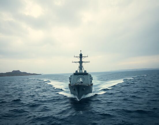 U.S. Navy destroyer sailing through the Strait of Hormuz under overcast sky