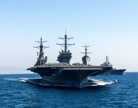 US Navy aircraft carrier patrolling Strait of Hormuz enforcing Iran blockade for navigation freedom restoration.