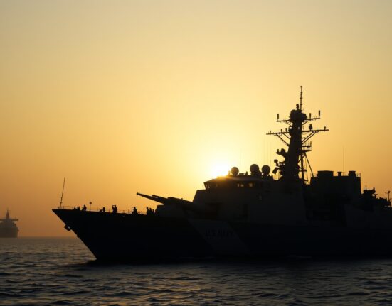 US Navy destroyer patrolling the Strait of Hormuz at dawn after ceasefire collapse