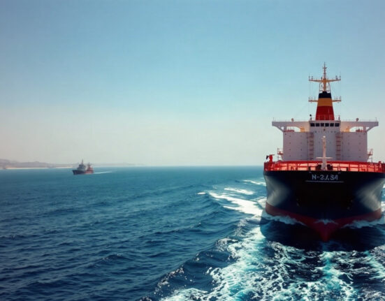 Oil tanker navigating the Strait of Hormuz with coastline in background