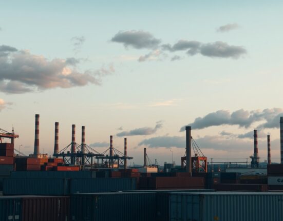 Italian industrial port and factory district at dusk, representing producer price trends.