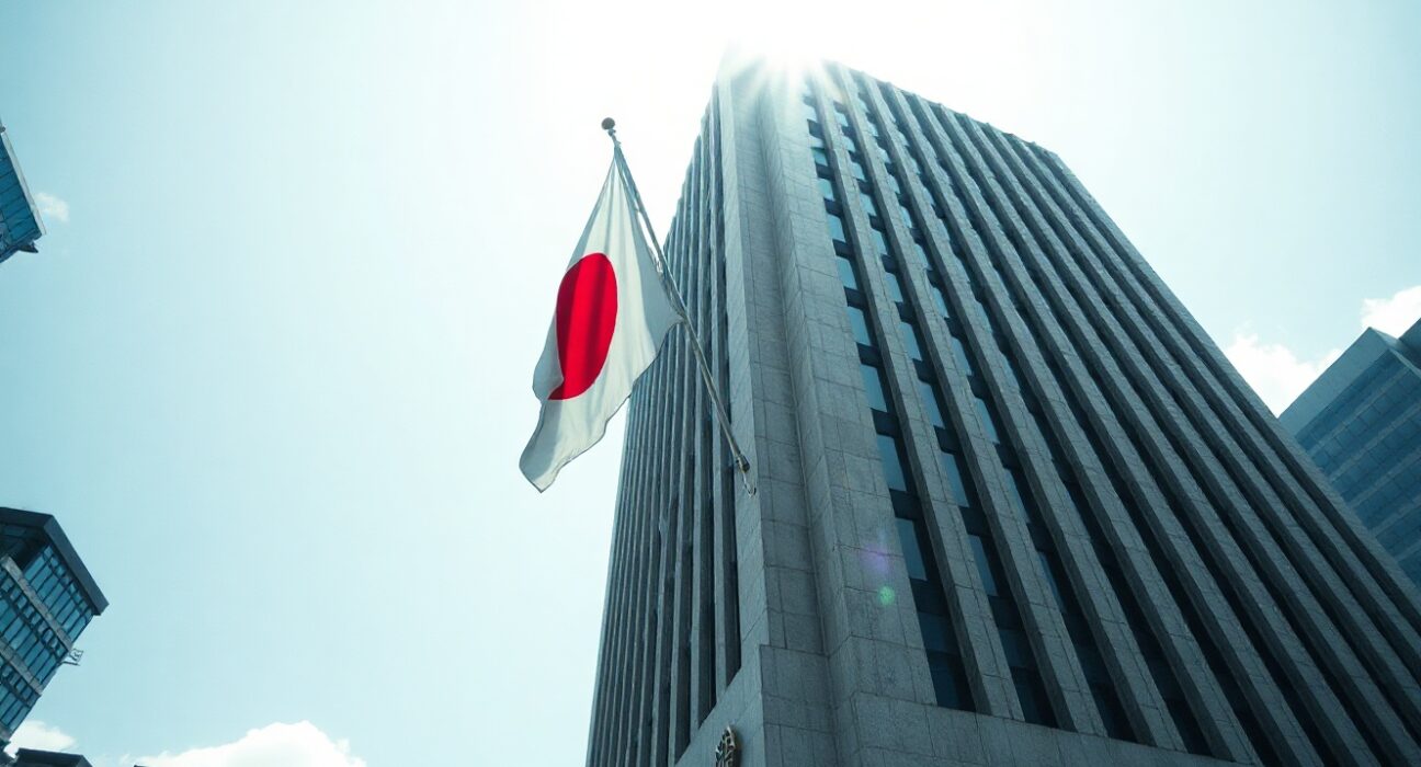 Bank of Japan headquarters in Tokyo on a clear day, symbolizing the central bank's role in setting monetary policy.