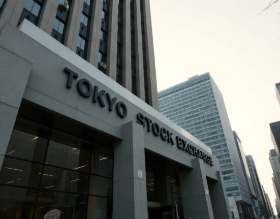 Tokyo Stock Exchange building on a clear day, representing Japan's financial markets.
